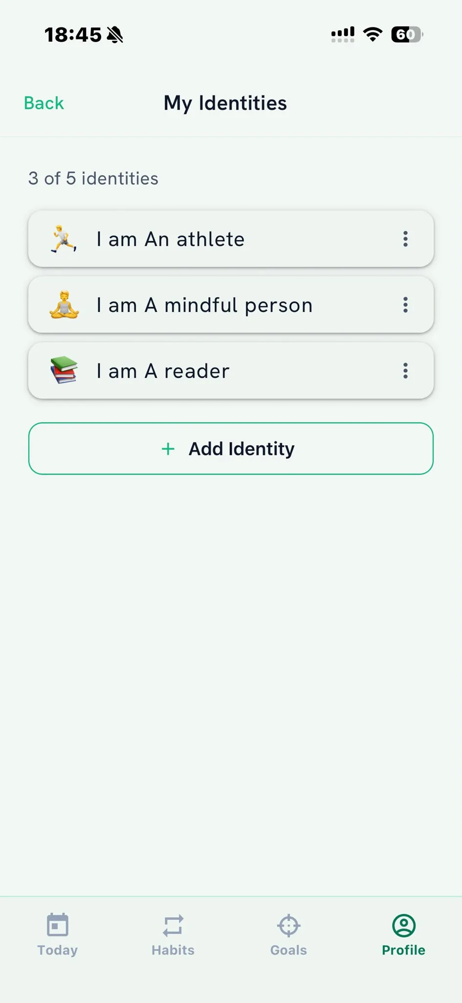 My Identities screen listing identity statements with emoji icons, ready to link habits to